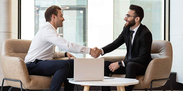 Two businessmen shake hands