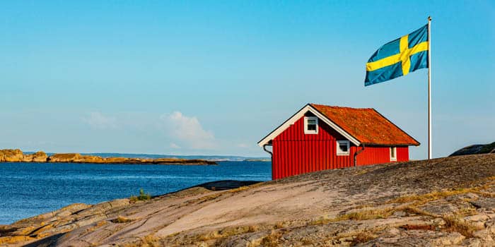 Swedish flag and a house on an island in Sweden.