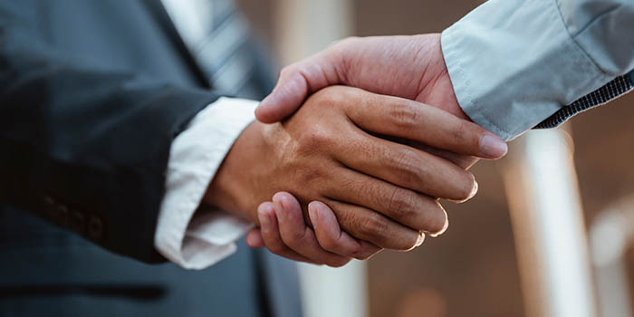 Two businessmen shake hands