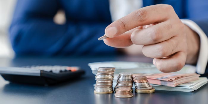 Businessman stacks coins