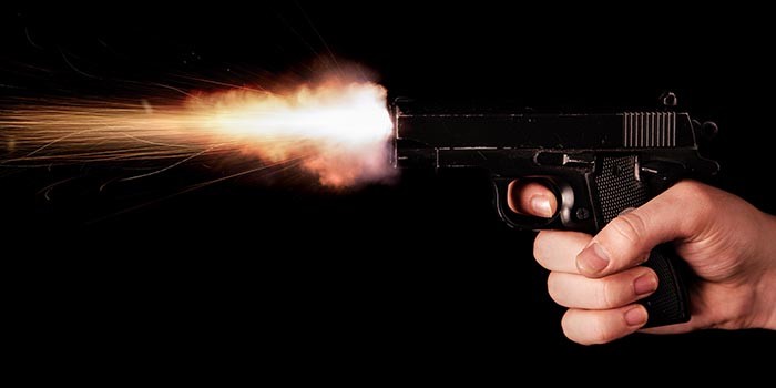 An assailant shoots with a gun