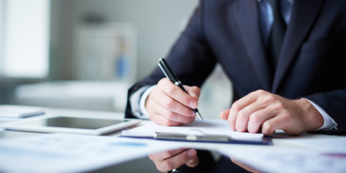 A businessman signing a document