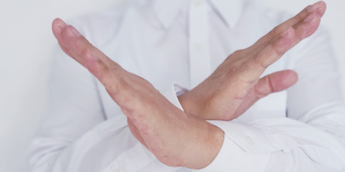 Businessman with crossed hands, a gesture for rejection