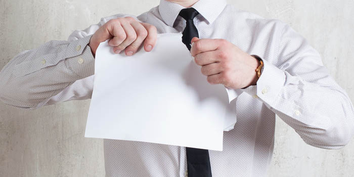 Businessman tears a document