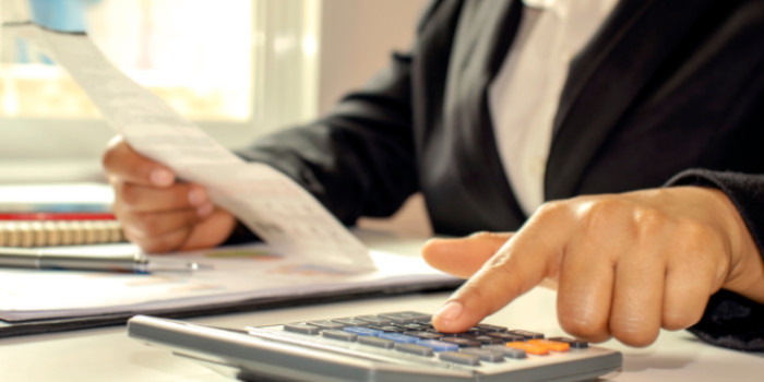 A businesswoman using a calculator