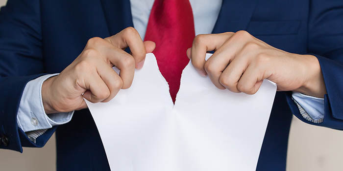 Businessman tears a piece of paper