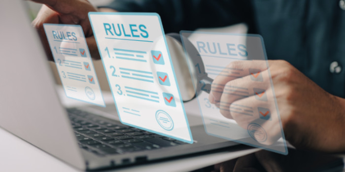 Businessman in front of computer reviewing rules